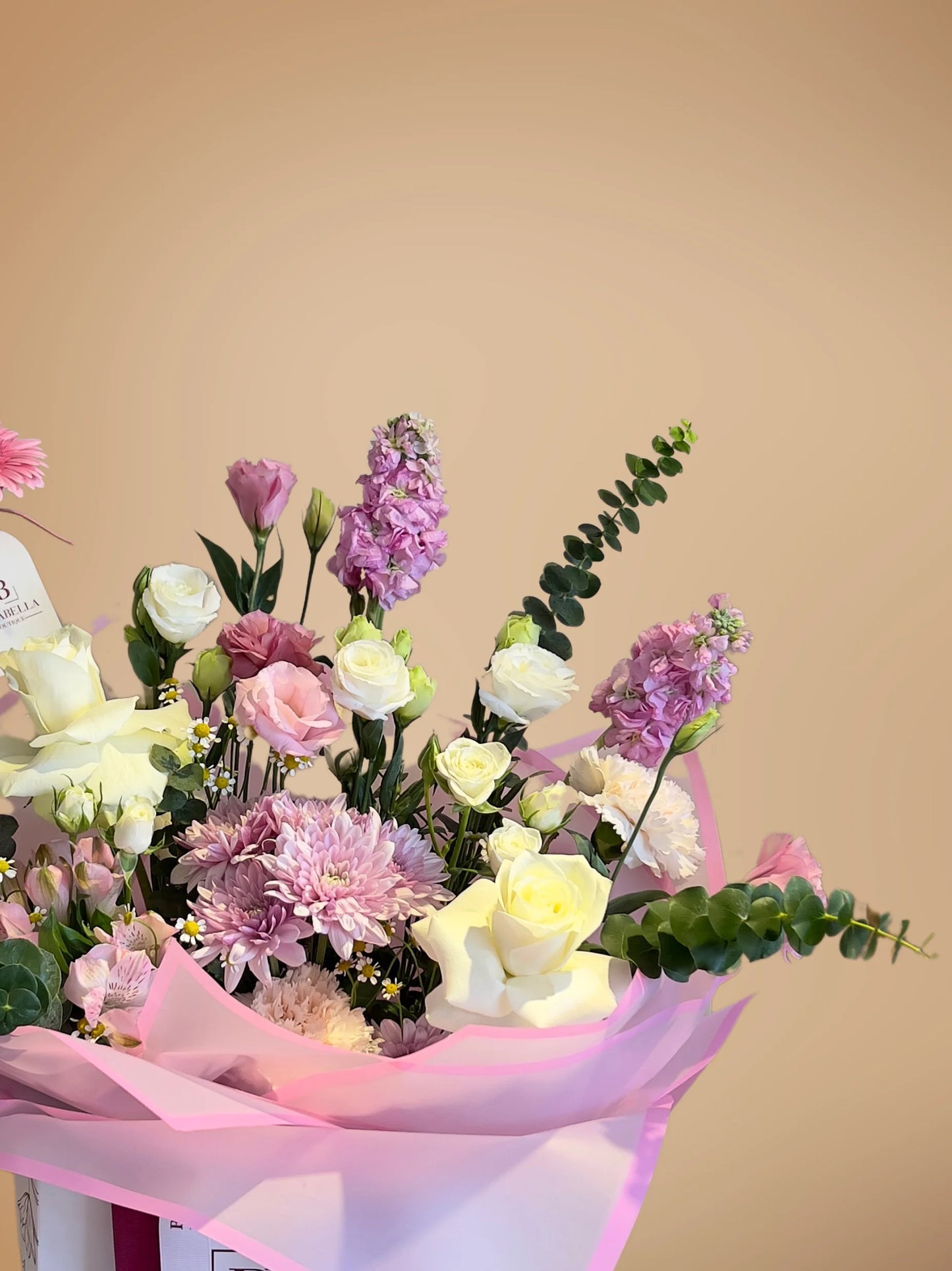Serenade in Bloom Handbag Arrangement with soft pink, purple, and white flowers in a chic handbag, available at a flower boutique with delivery to Dubai, Sharjah, and Muwaileh.
