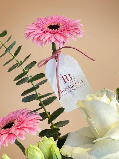 Serenade in Bloom Handbag Arrangement with soft pink, purple, and white flowers in a chic handbag, available at a flower boutique with delivery to Dubai, Sharjah, and Muwaileh.